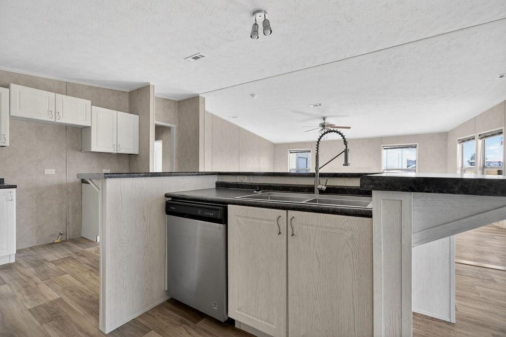 154 Firefly Drive Springtown, TX 76082 - Photo 19 of 39 a kitchen with stainless steel appliances granite countertop a sink and cabinets