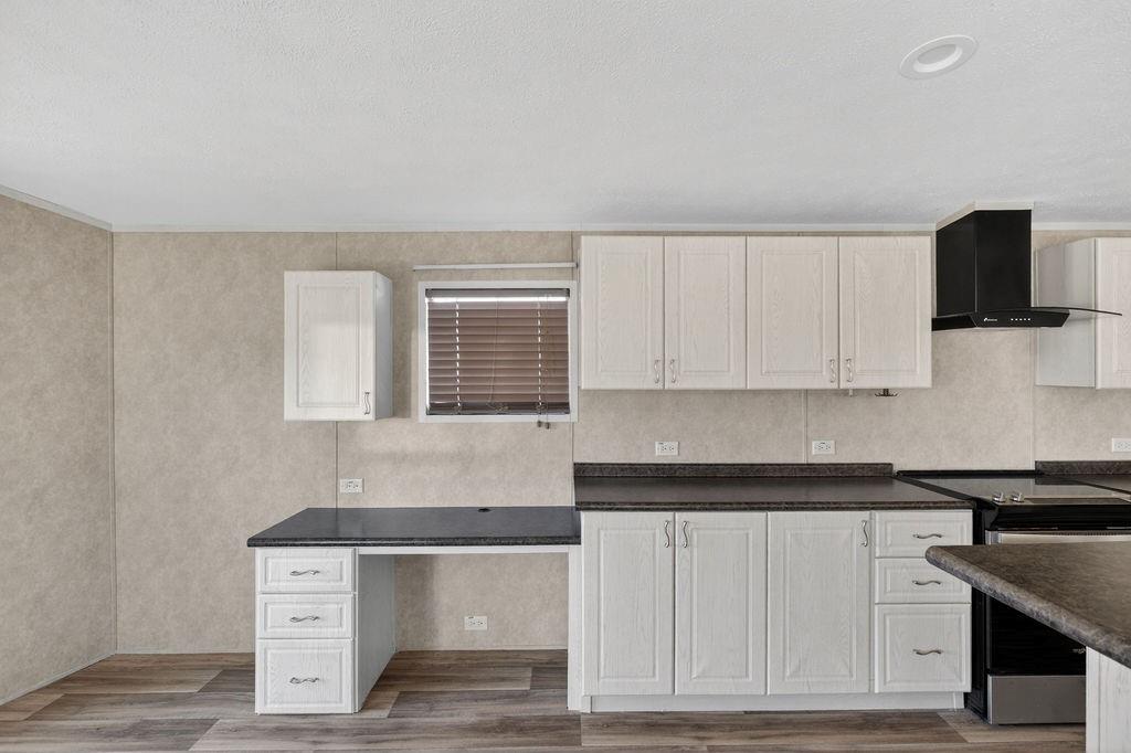 154 Firefly Drive Springtown, TX 76082 - Photo 20 of 39 a kitchen with granite countertop white cabinets and black appliances