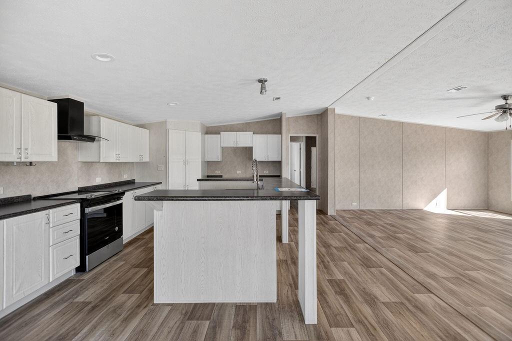 154 Firefly Drive Springtown, TX 76082 - Photo 22 of 39 a kitchen with stainless steel appliances a stove top oven a sink and a refrigerator