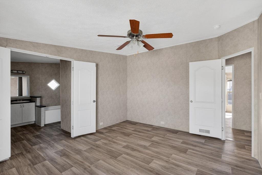 154 Firefly Drive Springtown, TX 76082 - Photo 23 of 39 wooden floor in an empty room with a window