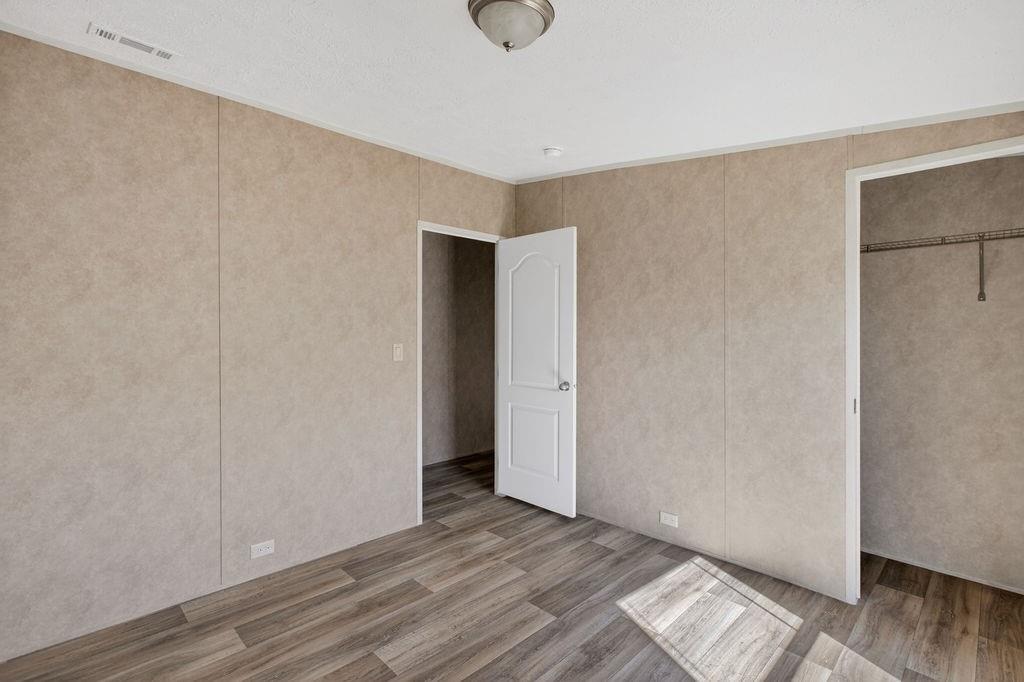 154 Firefly Drive Springtown, TX 76082 - Photo 24 of 39 a view of an empty room with wooden floor and closet
