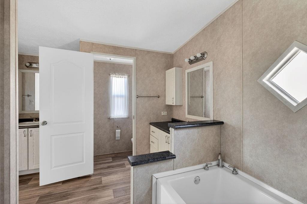 154 Firefly Drive Springtown, TX 76082 - Photo 25 of 39 a bathroom with a sink and a mirror
