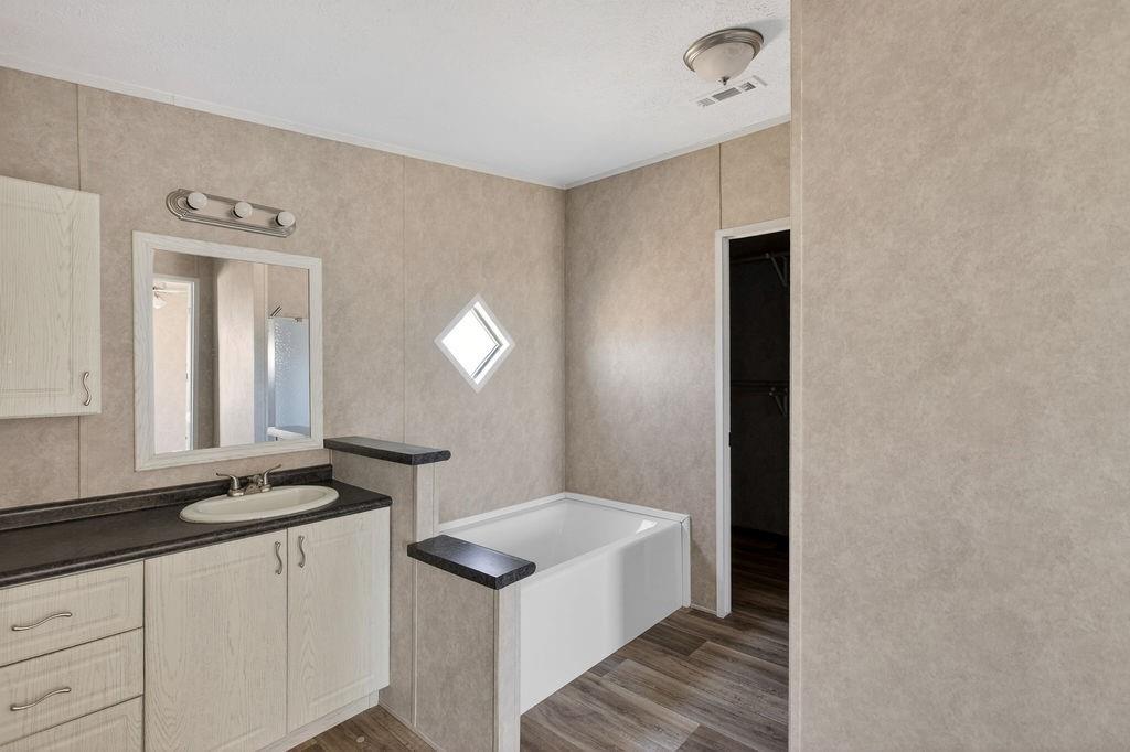 154 Firefly Drive Springtown, TX 76082 - Photo 26 of 39 a bathroom with a sink and a mirror