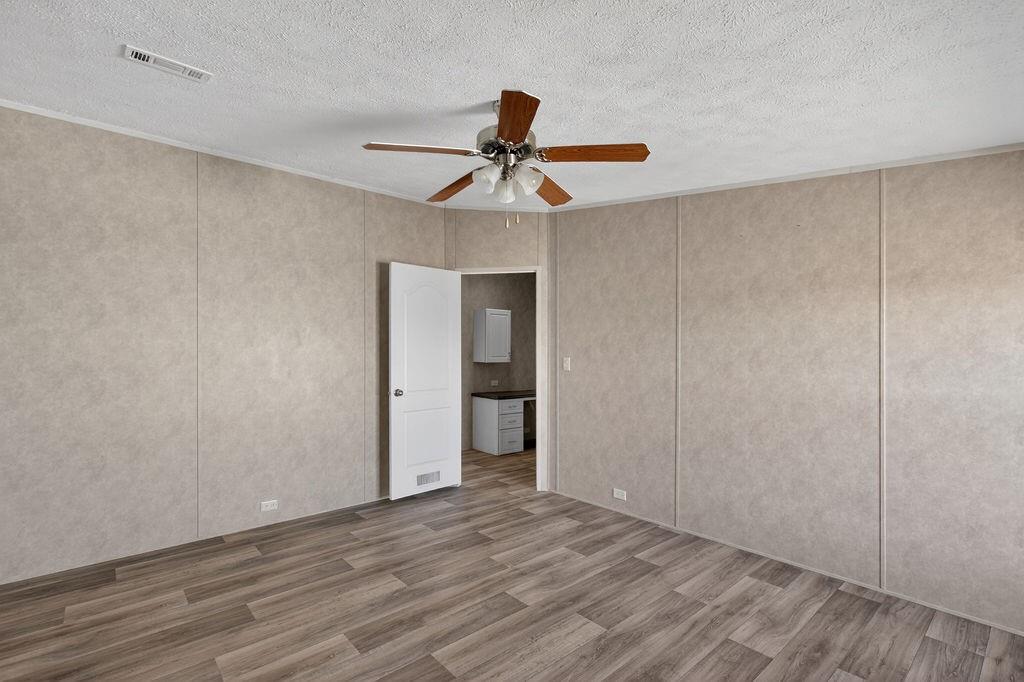 154 Firefly Drive Springtown, TX 76082 - Photo 27 of 39 a view of an empty room with window and wooden floor