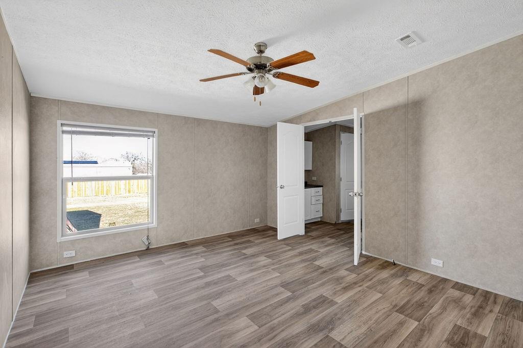 154 Firefly Drive Springtown, TX 76082 - Photo 28 of 39 wooden floor in an empty room with a window