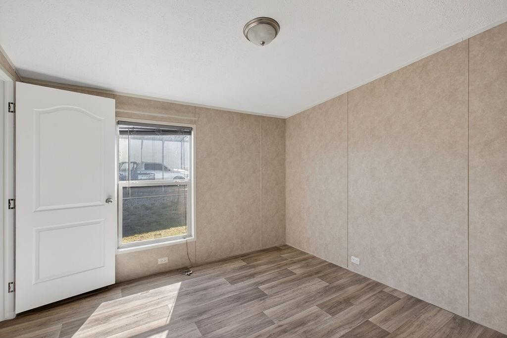 154 Firefly Drive Springtown, TX 76082 - Photo 29 of 39 a view of an empty room with wooden floor and closet