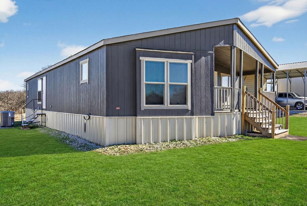 154 Firefly Drive Springtown, TX 76082 - Photo 3 of 39 a front view of a house with garden