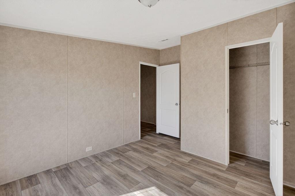 154 Firefly Drive Springtown, TX 76082 - Photo 31 of 39 a view of an empty room with wooden floor and closet