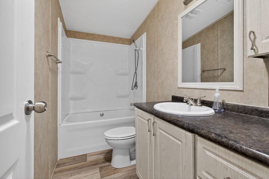 154 Firefly Drive Springtown, TX 76082 - Photo 33 of 39 a bathroom with a granite countertop sink toilet and shower