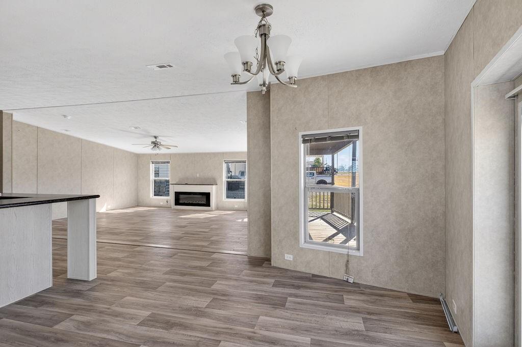 154 Firefly Drive Springtown, TX 76082 - Photo 8 of 39 a view of an empty room with window and wooden floor
