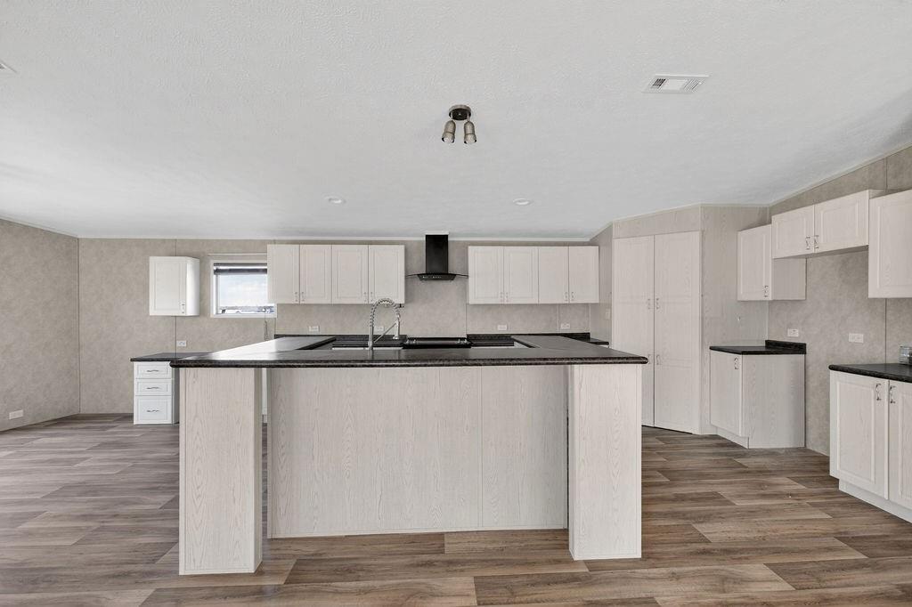 154 Firefly Drive Springtown, TX 76082 - Photo 10 of 39 a kitchen with stainless steel appliances granite countertop a stove and a sink