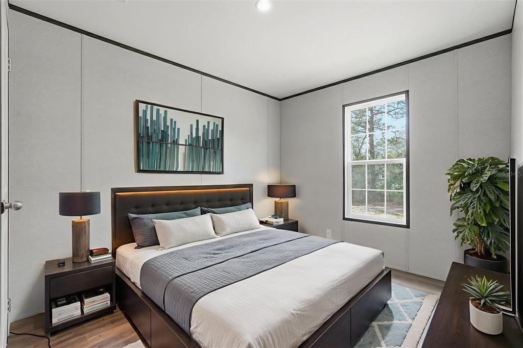 16837 Lashua Drive Spring Hill, FL 34610 - Photo 11 of 37 a bedroom with a bed and a potted plant next to a window