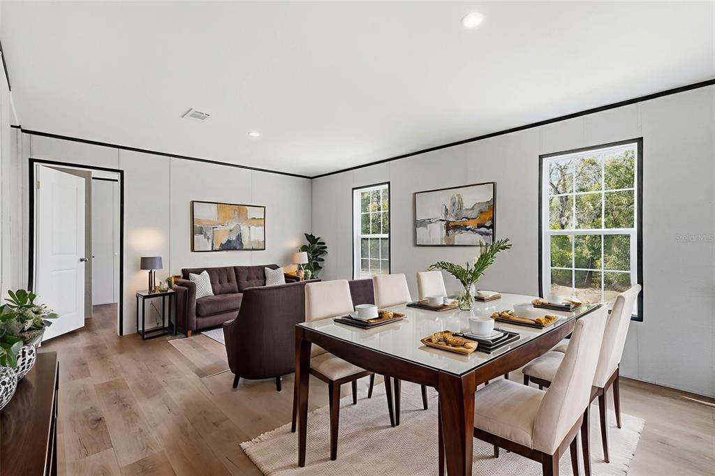 16837 Lashua Drive Spring Hill, FL 34610 - Photo 12 of 37 a view of a dining room with furniture window and wooden floor