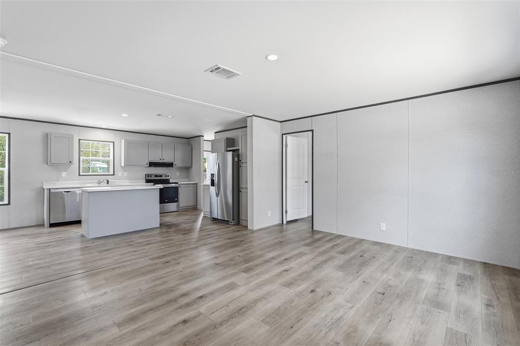16837 Lashua Drive Spring Hill, FL 34610 - Photo 13 of 37 a view of kitchen with cabinets and wooden floor