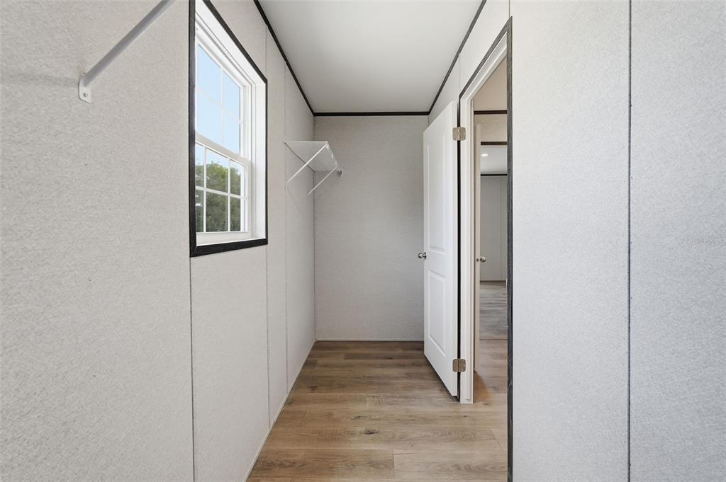 16837 Lashua Drive Spring Hill, FL 34610 - Photo 20 of 37 a view of a hallway with wooden floor and windows