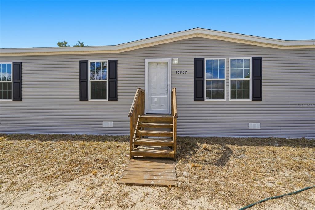 16837 Lashua Drive Spring Hill, FL 34610 - Photo 29 of 37 a view of a house with wooden fence