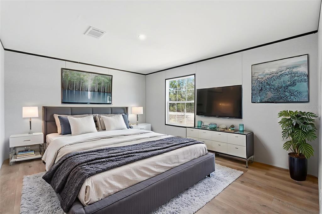 16837 Lashua Drive Spring Hill, FL 34610 - Photo 3 of 37 a bedroom with a bed and a flat screen tv