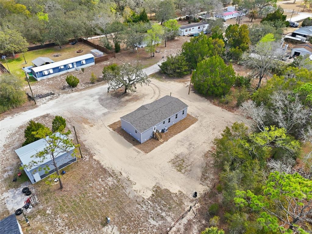 16837 Lashua Drive Spring Hill, FL 34610 - Photo 32 of 37 an aerial view of a house with a yard and lake view