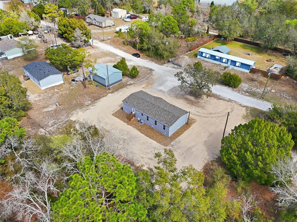 16837 Lashua Drive Spring Hill, FL 34610 - Photo 33 of 37 an aerial view of a house with a yard and greenery