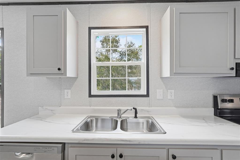 16837 Lashua Drive Spring Hill, FL 34610 - Photo 7 of 37 a kitchen with a sink and cabinets