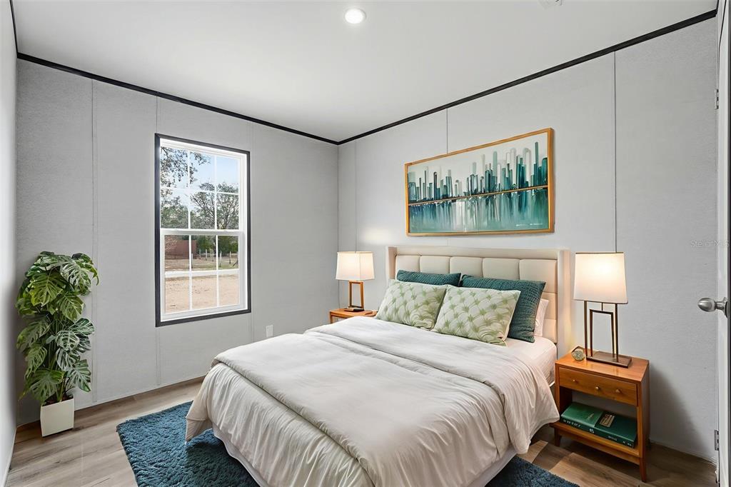 16837 Lashua Drive Spring Hill, FL 34610 - Photo 10 of 37 a bedroom with a bed and a painting on the wall