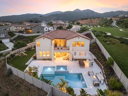 an aerial view of residential houses with outdoor space and river