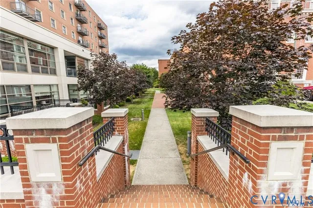 a view of a patio with swimming pool and sitting area