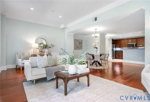 a living room with furniture and wooden floor