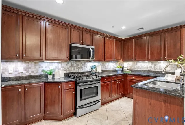 a kitchen with wooden cabinets and stainless steel appliances
