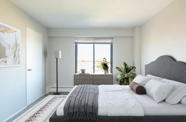 a bedroom with a bed and a window