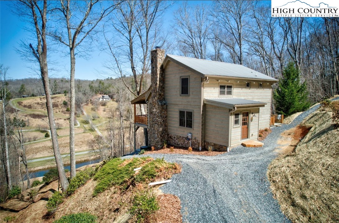 a front view of a house with a yard covered with snow