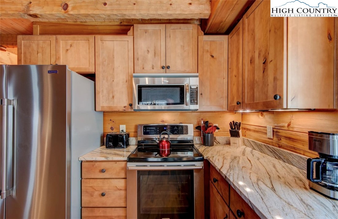 337 Rivers Crest Road Boone, NC 28607 - Photo 18 of 46 a kitchen with stainless steel appliances granite countertop a refrigerator and a stove top oven