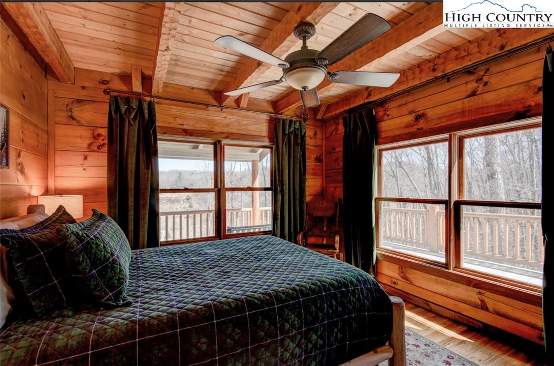 337 Rivers Crest Road Boone, NC 28607 - Photo 22 of 46 a bedroom with a bed and a large window with outer view