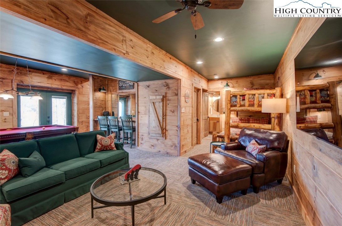 337 Rivers Crest Road Boone, NC 28607 - Photo 35 of 46 a living room with furniture a rug and a chandelier