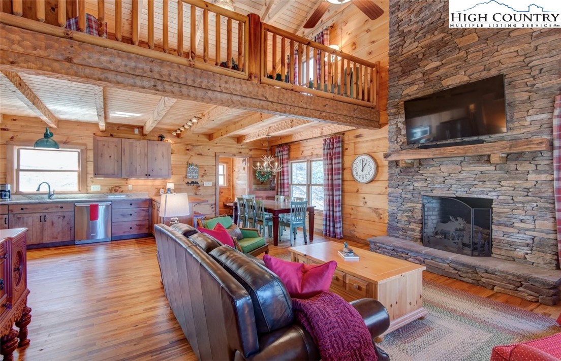 337 Rivers Crest Road Boone, NC 28607 - Photo 9 of 46 a living room with furniture a flat screen tv and a fireplace