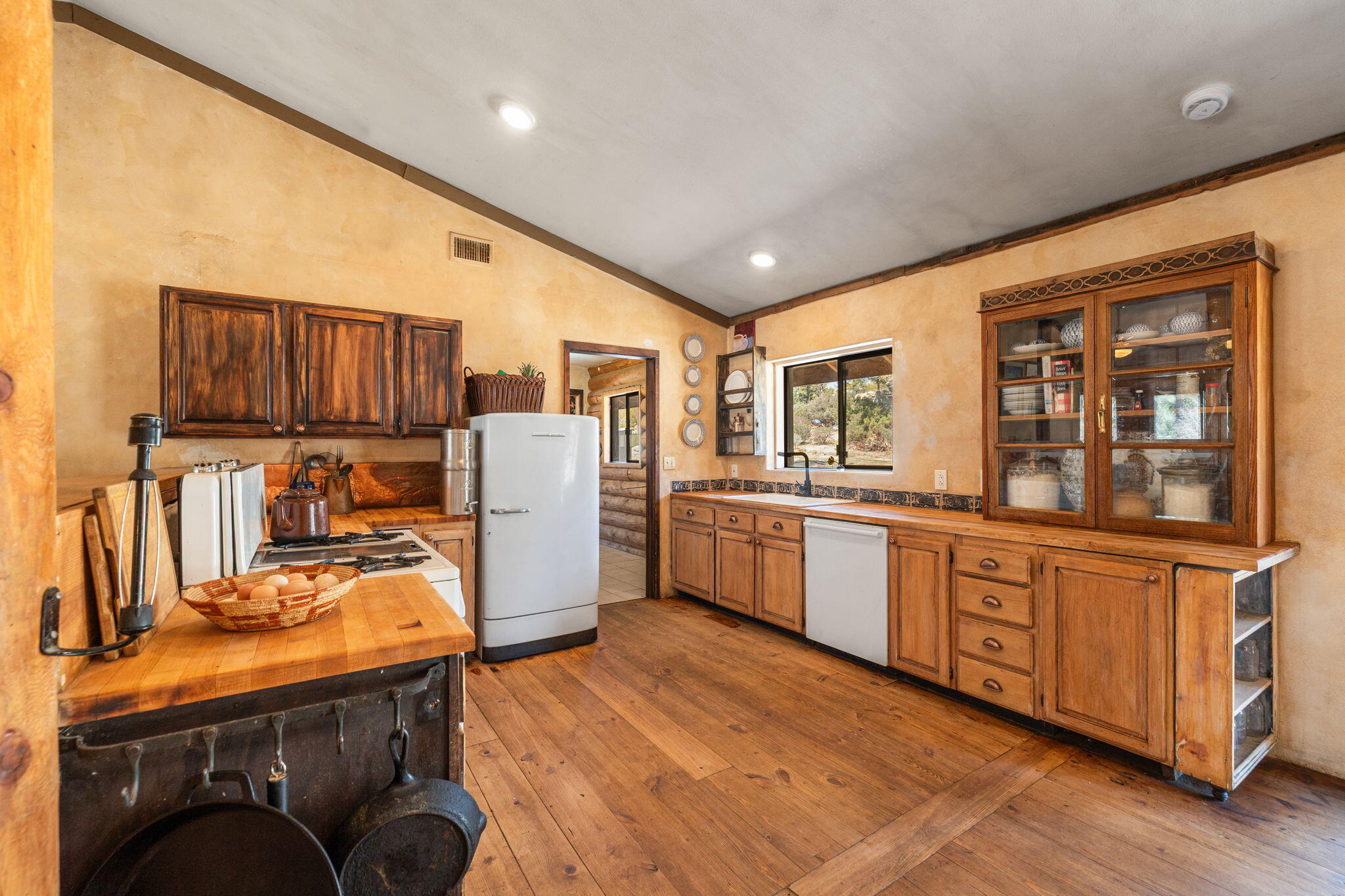 60640 Table Mountain Road Mountain Center, CA 92561 - Photo 12 of 53 a kitchen with refrigerator cabinets and wooden floor