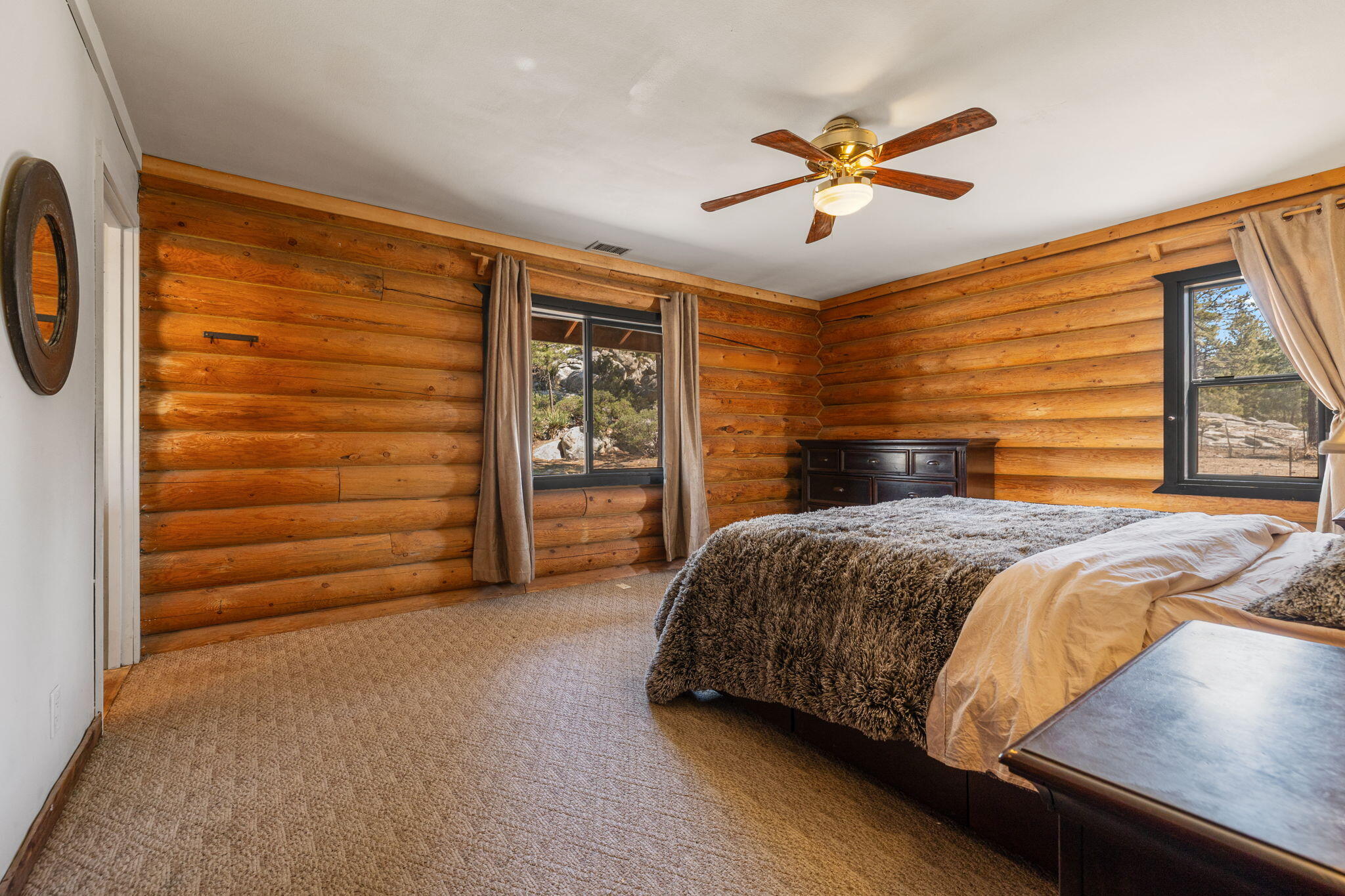 60640 Table Mountain Road Mountain Center, CA 92561 - Photo 18 of 53 a bedroom with a bed and a ceiling fan