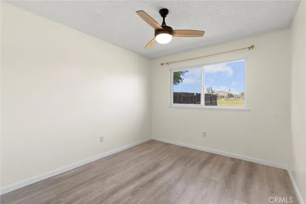 a view of an empty room and wooden floor