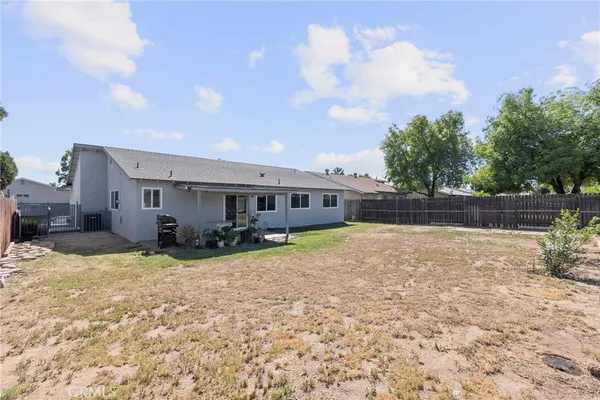 a view of a house with backyard porch and sitting area