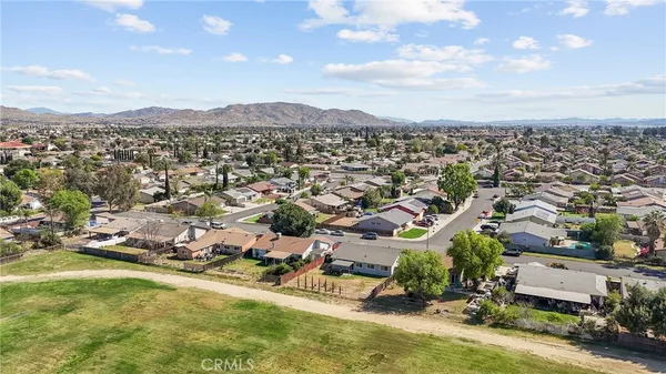an aerial view of a house with a yard