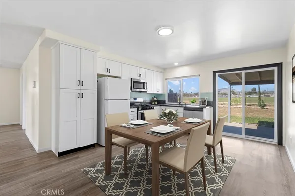 a kitchen with a refrigerator a sink and cabinets