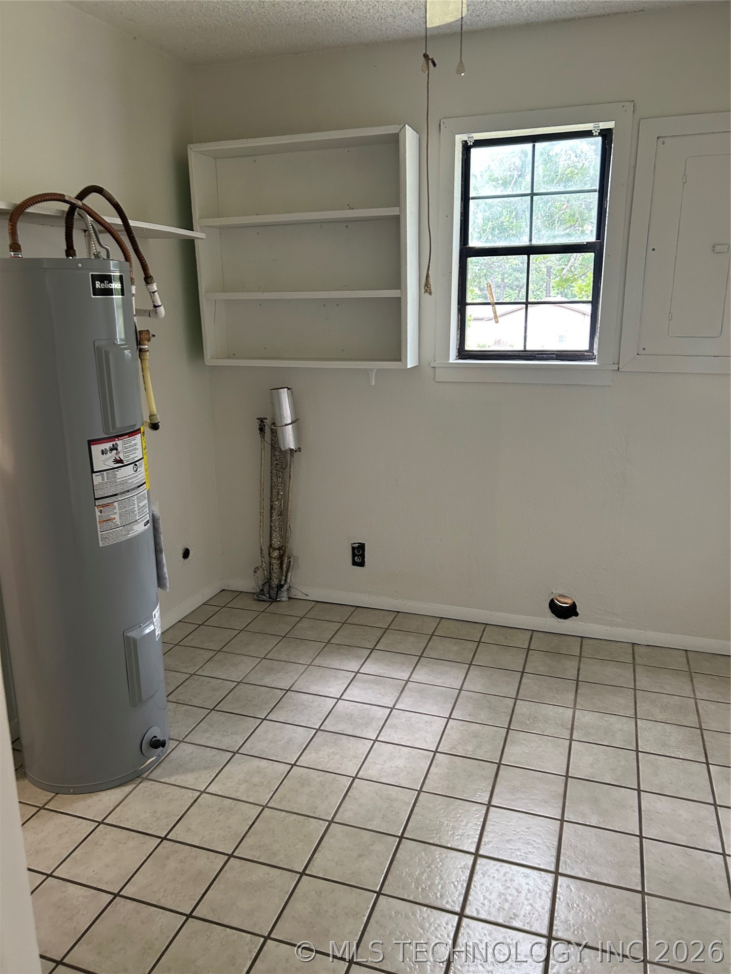 110955 East 1110 Road Sallisaw, OK 74955 - Photo 12 of 22 Utility room with ceramic tile flooring, a window providing natural light, and a built-in shelving unit