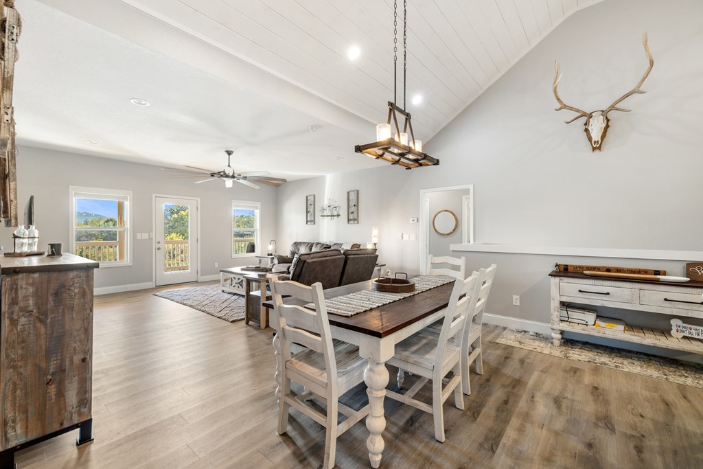 308 Mystic Ridge Blairsville, GA 30512 - Photo 12 of 68 a living room with furniture a chandelier and a flat screen tv