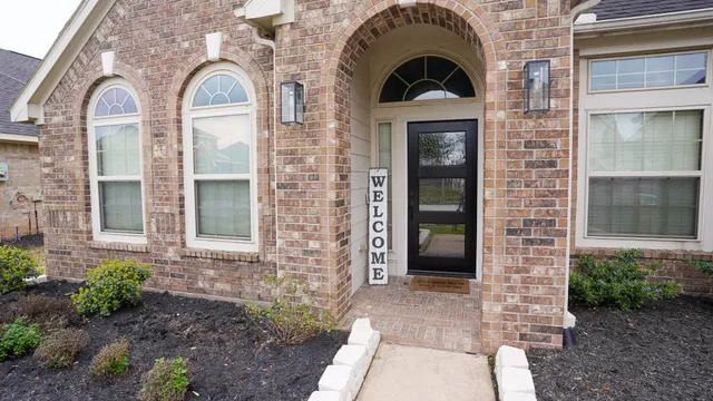 a view of a brick house with many windows