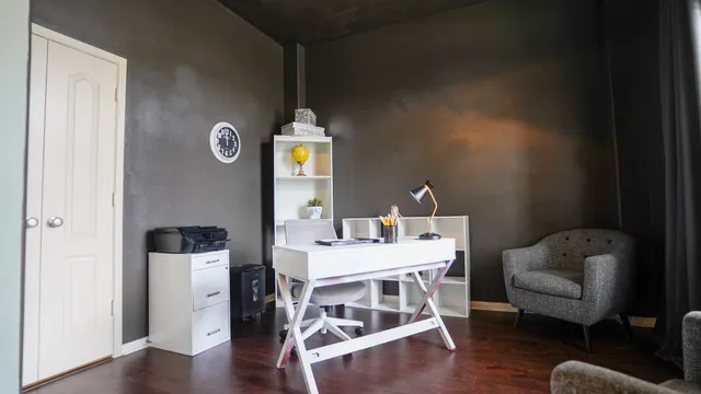 a bedroom with furniture and a wooden floor