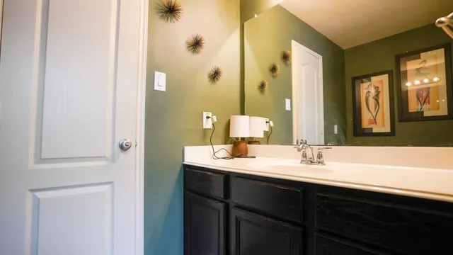 a bathroom with a double vanity sink and a mirror