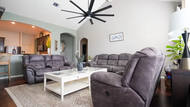 a living room with furniture fireplace and a potted plant
