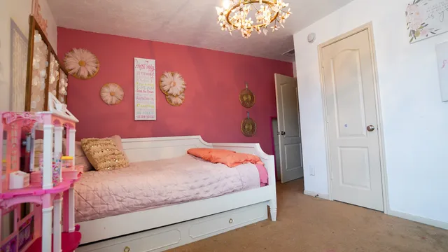 a bedroom with a bed and a chandelier