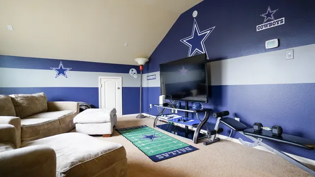 a living room with furniture a flat screen tv and gym equipment