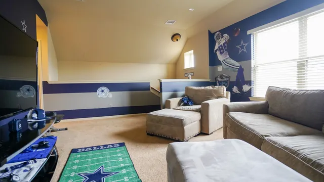 a bedroom with two beds and a flat screen tv